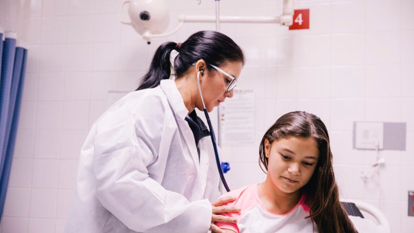 Doctor treating a young patient in Puerto Rico.