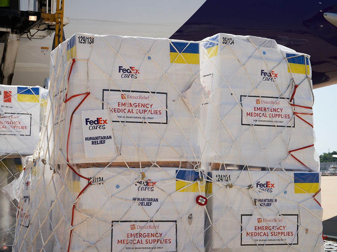 Four pallets of emergency medical aid loading onto FedEx cargo plane